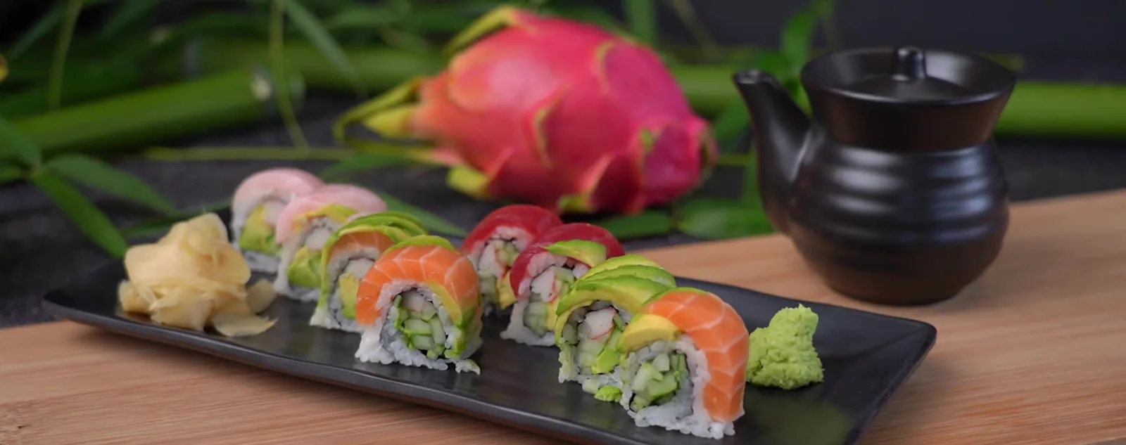 Kali Rainbow sushi roll topped with salmon, tuna, yellowtail and avocado